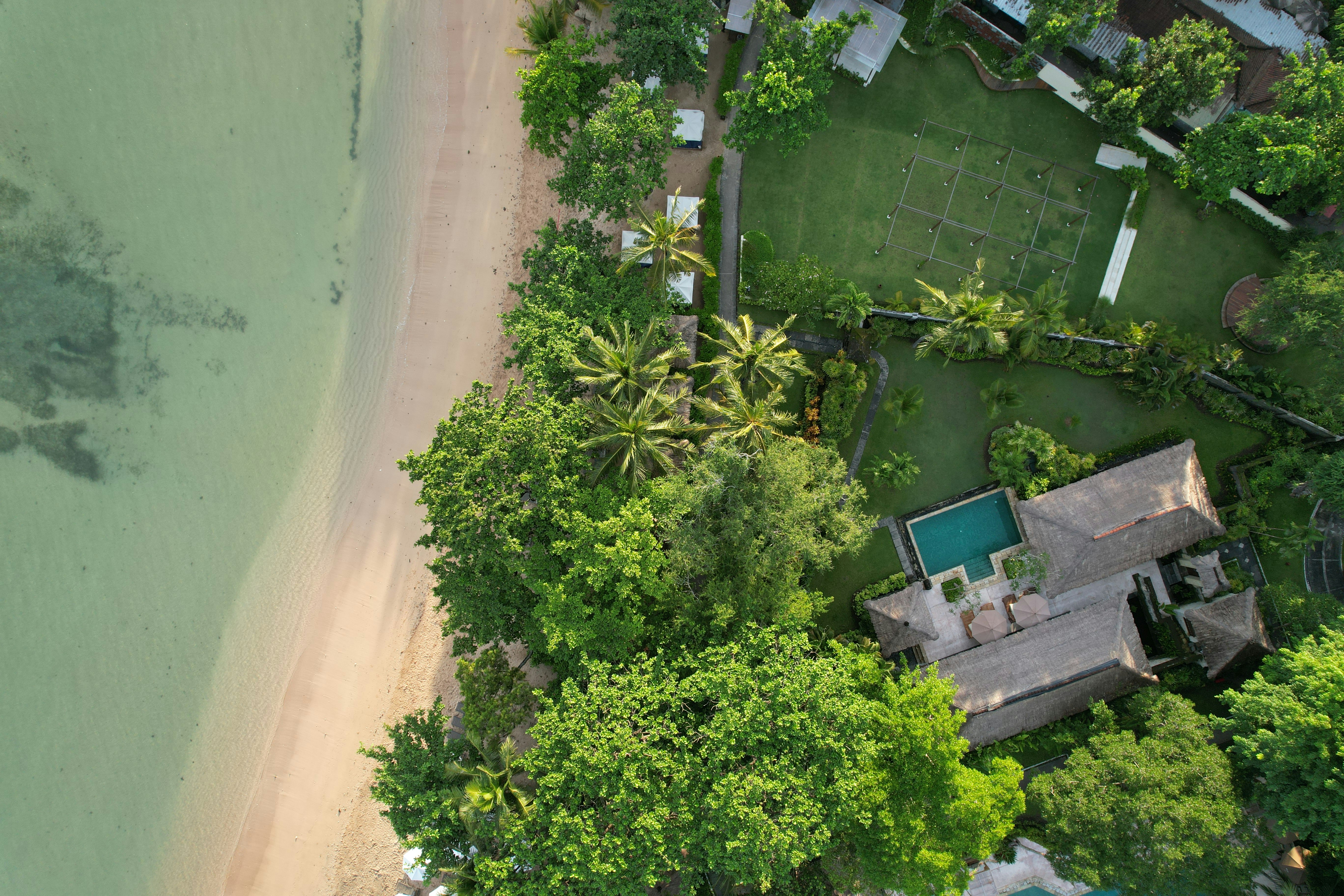 Aerial view of beachfront private villa with pool